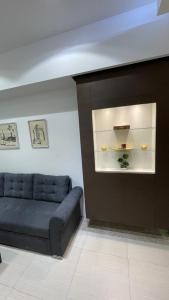 a living room with a blue couch and a wall at TIM Apartment Sarajevo with private parking in Sarajevo