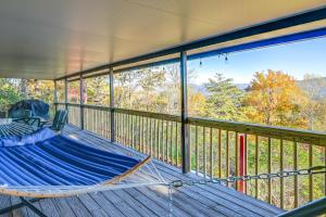 a hammock on a deck with a view of the mountains at Stunning Franklin Cabin with Deck and Mountain Views in Franklin