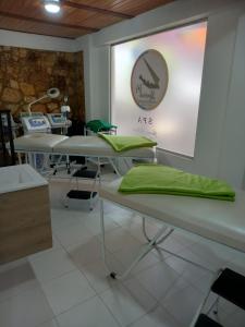 Habitación con mesas con almohadas verdes. en HOTEL BOUTIQUE 14 LANCEROS, en Paipa