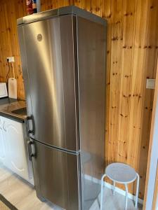 a large stainless steel refrigerator in a kitchen at Very centrally located apartment with free parking in Tromsø