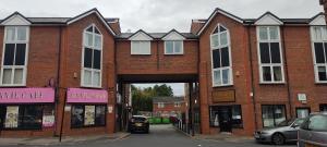 a large brick building with a tunnel in it at Modern 1-Bed Flat in Wigan in Wigan