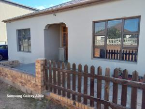 a house with a wooden fence in front of it at Villa43guesthouse in Cape Town