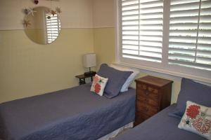 a bedroom with two beds and a mirror at 1801 Downing Ave. in Cambria +18 photos