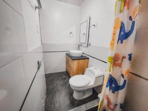 a small bathroom with a toilet and a sink at Departamento de Estreno in Huaraz