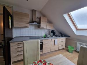 an attic kitchen with a sink and a window at Cheerful Roof Flat in a Private German Style House in Mannheim
