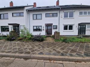 a white house with a brick driveway at Cheerful Roof Flat in a Private German Style House in Mannheim