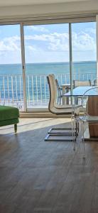 a living room with a view of the ocean at Le Splendid in La Baule
