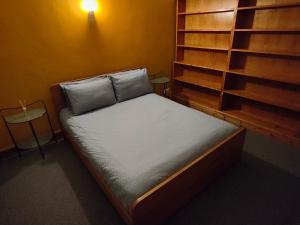 a bed in a room with a book shelf at The Mill Lade - Hidden House in Arbroath