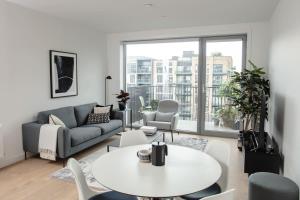 a living room with a couch and a table and chairs at City Apartments by Dublin At Home in Dublin