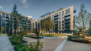a park with benches in front of tall buildings at City Apartments by Dublin At Home in Dublin