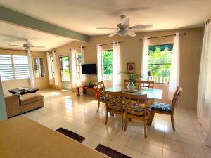 a living room with a dining room table and chairs at Casa Mia Guest House in Rincon