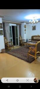 a living room with a chair and a rug at مدينه نصر القاهره in Cairo