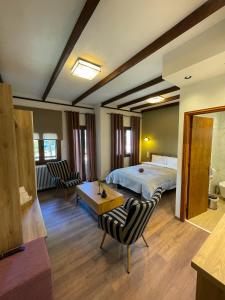 a bedroom with a bed and a table and chairs at Giataki in Elati