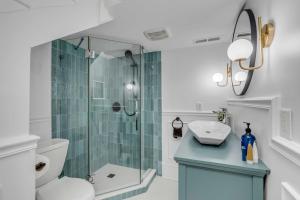a bathroom with a shower and a toilet and a sink at The Palmetto House B- Walk To King Street in Charleston +40 photos