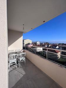 a balcony with chairs and a view of a city at Hotel Palace Struga in Struga