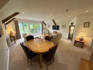 a living room with a wooden table and a couch at Meadows Barn in Chelmsford