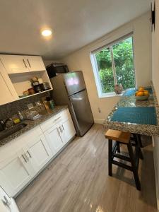 a kitchen with a counter top and a refrigerator at Beach vibes 2 bedrooms house in Miami