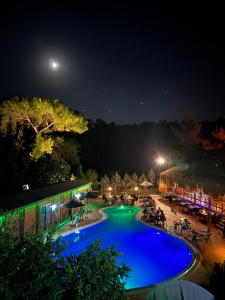 a view of a swimming pool at night at Olympos Village Relaxury Hotel in Olympos