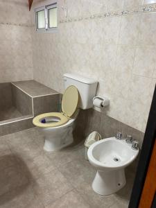 a bathroom with a toilet and a sink at Cabañas flotter in Villa Ventana +9 photos