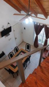 a dining room with a table and chairs and a ceiling at Cabañas Rincón Potrero in Potrero de los Funes