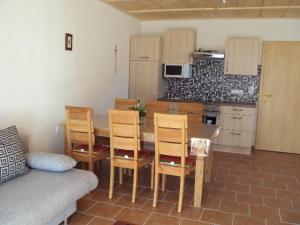 a kitchen with a table and chairs in a room at Panoramahof Holly in Obervellach +18 photos