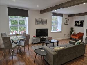 a living room with a couch and a table at New Duplex Period Delight in Burnley