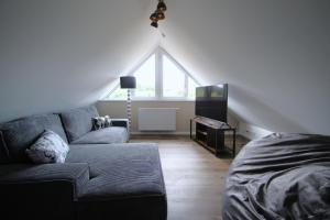 a living room with a couch and a window at Sunseeker House 2 in Bad Schwartau