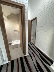 a bathroom with a bath tub and a sink at Cassa-Grande in Bozovici +36 photos