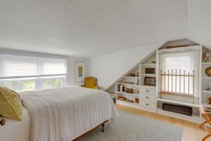a white bedroom with a bed and a staircase at Cozy Cottage in Historic Village Near Wineries! in Milan