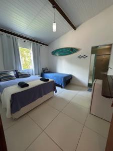 a bedroom with two beds and a mirror in it at Flats Maraú - Taipu de Fora Bahia in Marau