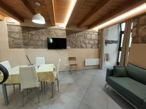 a living room with a table and a couch at Il Paradosso Suite in Viterbo