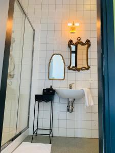 a bathroom with a sink and a mirror at De Lotuspoort met Mihr's B&B in de Abdij van Bornem in Bornem