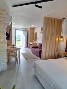 a bedroom with a bed and a living room at Terrazza Suites in Paphos City