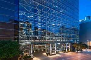 a large glass building with a courtyard in front of it at Omni Austin Hotel Downtown in Austin