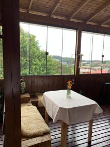a room with a table with a vase of flowers on it at Pousada Cape Town - Cambará do Sul in Cambara do Sul