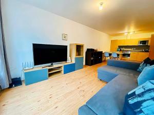 a living room with a couch and a flat screen tv at Secure 2BR 1BA Apartment for 6 in Colindale