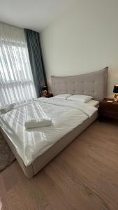 a large white bed in a bedroom with a window at Queen 4 in Belgrade