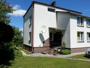 a white house with a satellite on the side of it at Noclegi Przy Stadninie in Janów Podlaski