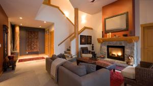 a living room with a fireplace and a couch at Goldenwood 8336 - Large Townhouse, Golf Course Views, Hot Tub, Patio - Whistler Platinum in Whistler