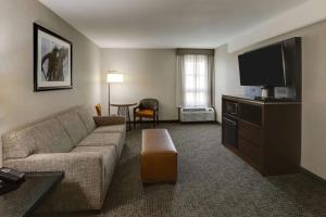 a living room with a couch and a flat screen tv at Drury Inn & Suites St Joseph in Saint Joseph