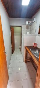 a small bathroom with a sink and a table at Hostel Mariscal in Corrientes