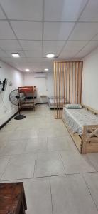 a room with two beds in the middle of it at Hostel Mariscal in Corrientes