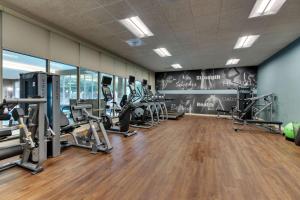 a gym with several treadmills and cardio machines at Drury Plaza Hotel Dallas Arlington in Arlington