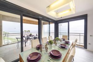 a dining room with a table and chairs with a view of the ocean at Fantastic penthouse 270m2 with amazing sea views in Roquetas de Mar