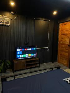 a room with a flat screen tv on a table at Zoom BnB in Naga
