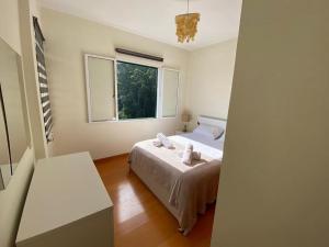 a small bedroom with a bed and a window at The Hideaway Retreat in Santo da Serra