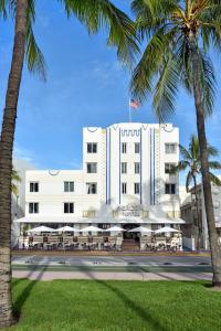 a hotel with palm trees in front of it at Beacon South Beach Hotel in Miami Beach