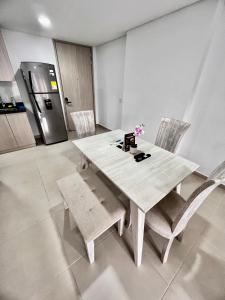a white dining table and chairs in a kitchen at vista a la ciudad , entretenimiento , cerca a todo 1802 in Sabaneta
