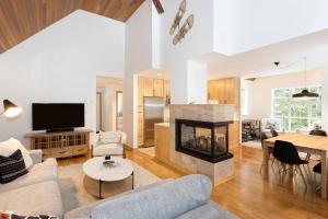 a living room with a couch and a fireplace at Snowbird 304 - Beautiful Townhome with Hot Tub & Secure Parking - Whistler Platinum in Whistler