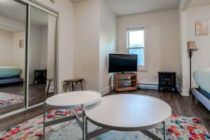 a living room with a table and a tv at Historical Building 1br 1ba Walk To Rogers Place in Edmonton